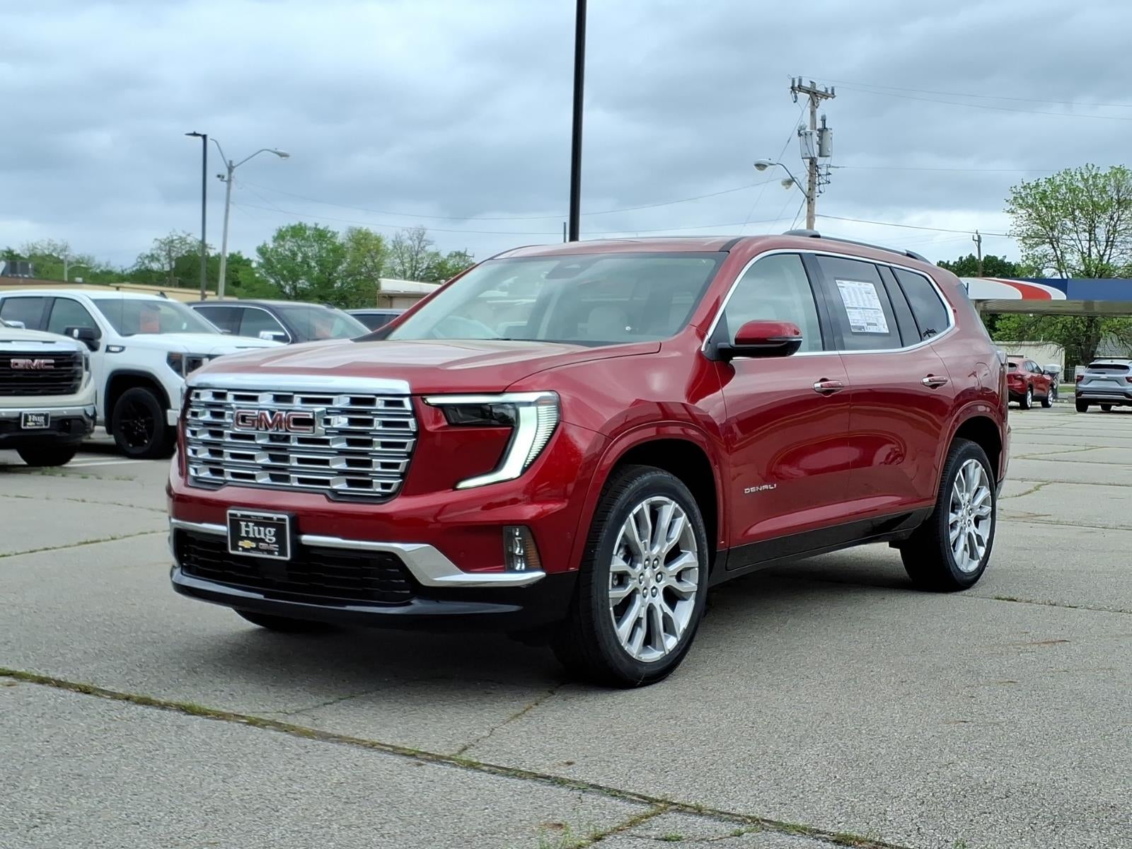 2026 GMC Acadia Denali in Volcanic Red Tintcoat — front three-quarter view
